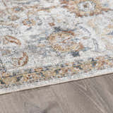 Close-up of the Dion Washable Floral Rug showing its charcoal, beige, and gray traditional pattern and soft texture. Pile