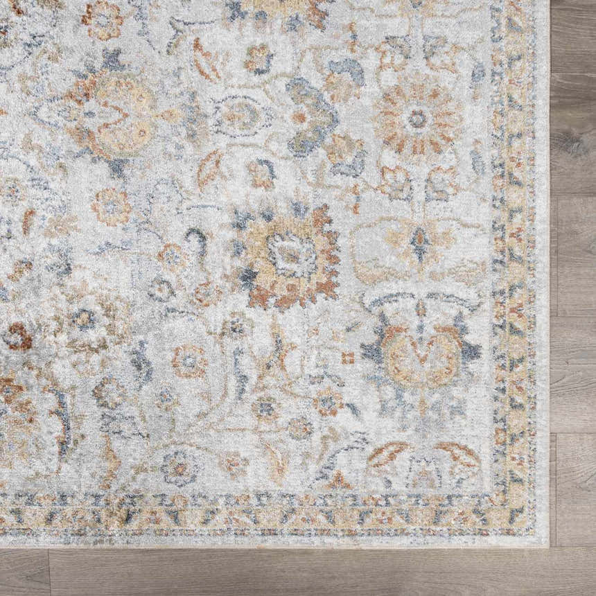 Close-up of the Dion Washable Floral Rug, showcasing its charcoal, beige, and gray floral pattern and traditional style. Swatch