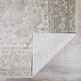 Close-up of Gael Boutique Washable Rug showing light blue, olive, and tan vintage pattern and machine woven construction. Fold