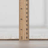 Close up of the Gael Boutique Washable Rug pile height, showing the rug's thickness with an inch ruler. Pile