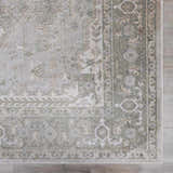 Close up of Gael Boutique Washable Rug showing traditional olive and light blue pattern and soft texture. Swatch