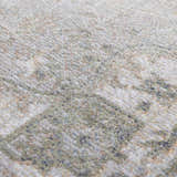 Close-up of Gael Boutique Washable Rug showing light blue, olive, and tan vintage pattern and soft polyester texture. Texture