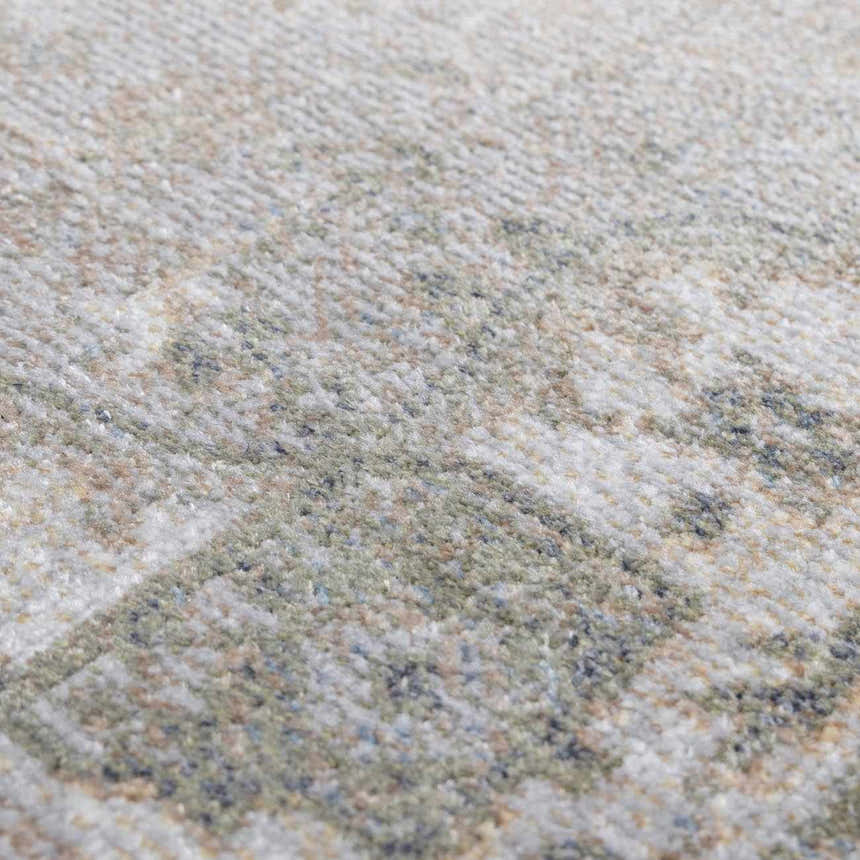 Close-up of Gael Boutique Washable Rug showing light blue, olive, and tan vintage pattern and soft polyester texture. Texture