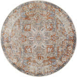 Close-up of round Rust Hera Washable Area Rug. Features a traditional pattern in rust, blue, tan, and off-white hues. Design-Round-67