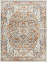 Close-up of the Rust Hera Washable Area Rug. Features a vintage, farmhouse-style pattern in rust, blue, and off-white tones. Design-Rectangle-710102