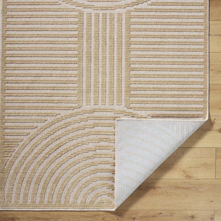 Close-up of the beige Deron Washable Area Rug showing the geometric pattern and non-slip backing. Fold