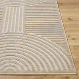 Close-up of the Deron Beige Washable Area Rug. Features a geometric pattern with beige and light brown lines on a cream background. Front
