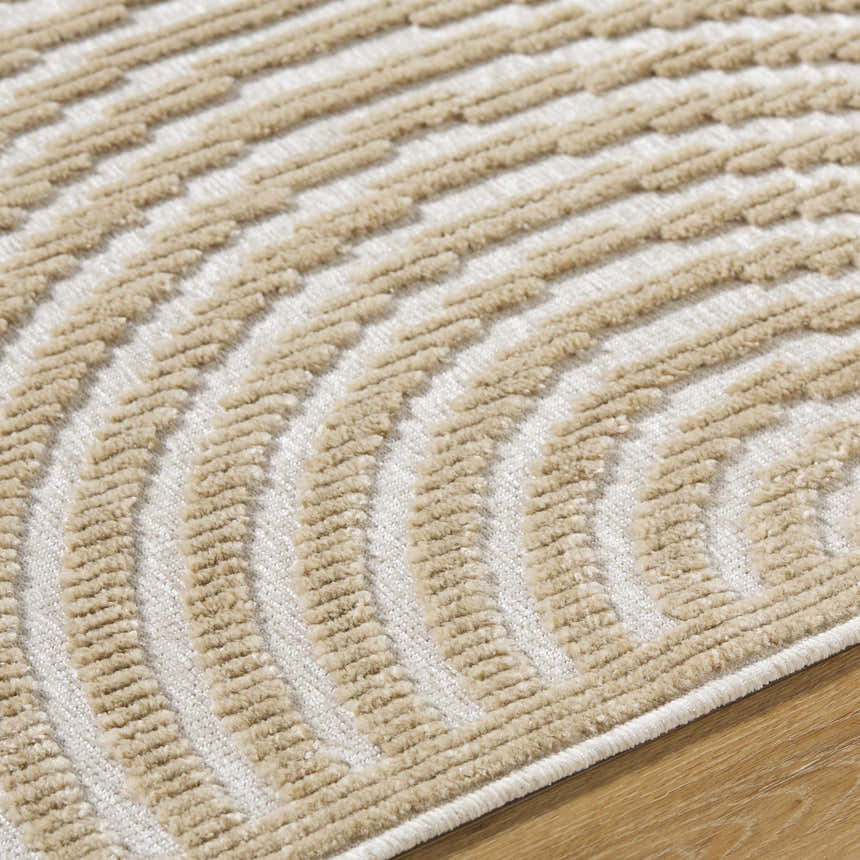Close-up of Deron Beige Washable Area Rug. Features a contemporary light brown, textured, arched pattern on a beige background. Texture