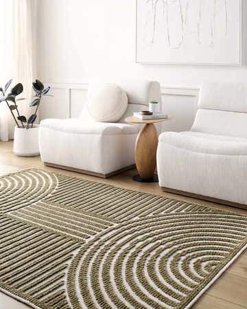 Living room scene with white chairs and the Deron Khaki Washable Area Rug featuring a geometric olive and white pattern. Roomscene-Rectangle