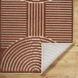Close-up of the Deron Brown Washable Area Rug showing its brown and white contemporary geometric pattern and machine-woven texture. Fold