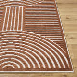 Close up of the Deron Brown Washable Area Rug. Brown and white geometric pattern. Contemporary style. Front