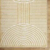 Close-up of Deron Mustard Washable Area Rug. Beige geometric design with semicircle and line patterns on an off-white base. Corner
