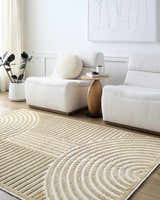 Minimalist living room with beige Deron Mustard Washable Area Rug, white chairs, wood side table, and neutral decor. Roomscene-Rectangle