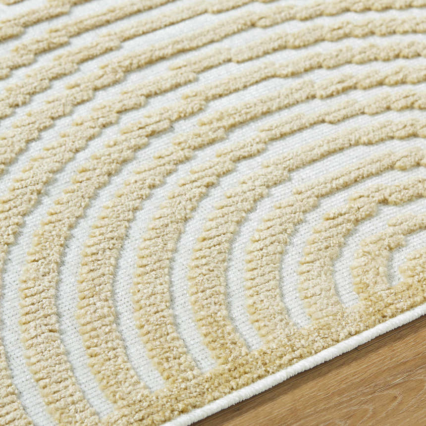 Close-up of Deron Mustard Washable Area Rug. Beige textured arches on an off-white background. Contemporary style. Texture