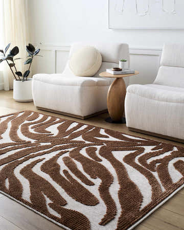 Living room scene with white chairs and a brown and off white Keto Washable Area Rug. Roomscene-Rectangle