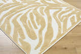 Close-up of the Keto White Washable Area Rug, featuring a contemporary mustard and white abstract pattern. Corner