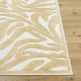 Close-up of the Keto White Washable Area Rug. Features a mustard abstract pattern on a white background. Front