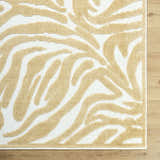 Close-up of the Keto White Washable Area Rug featuring a mustard abstract pattern on a white background. Corner
