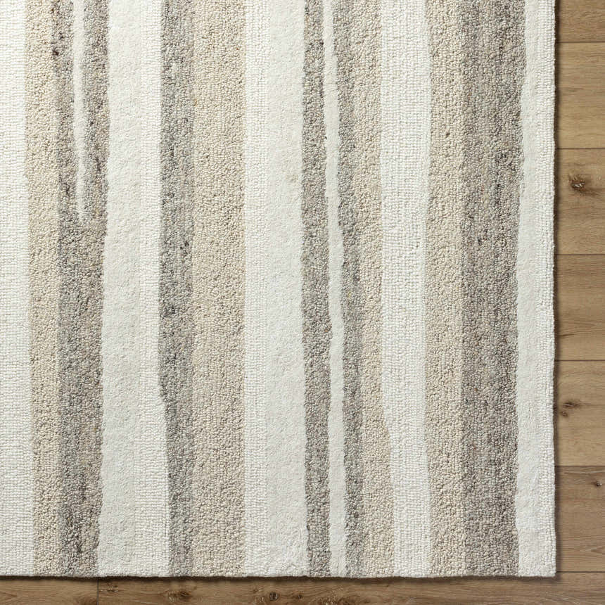 Close-up of the Siaju Taupe Area Rug. Hand-tufted wool rug with a striped pattern in neutral taupe and cream tones. Corner