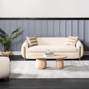 Living room scene with cream sofa, wood coffee table, and gray Speaks Traditional Textured Luxe Rug. Roomscene-Rectangle