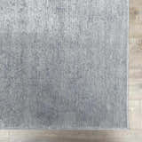 Close-up of the light gray Isako Blue & Gray Solid Washable Area Rug showing texture and machine-woven construction. Swatch