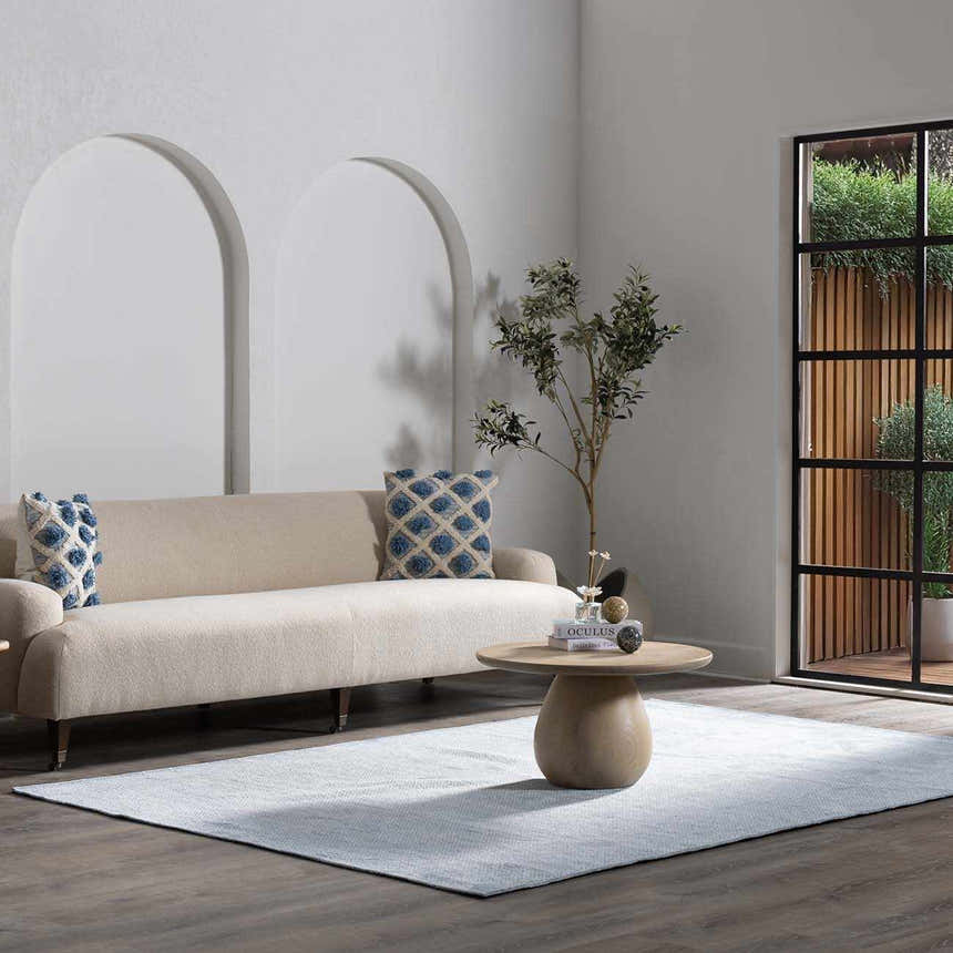 Living room with a beige sofa and the Isako Blue & Gray Solid Washable Area Rug on a dark wood floor. Roomscene-Rectangle