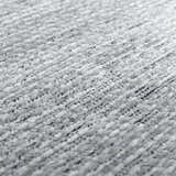 Close-up of the plush texture of the Isako Blue & Gray Solid Washable Area Rug. Light gray polyester fibers. Texture