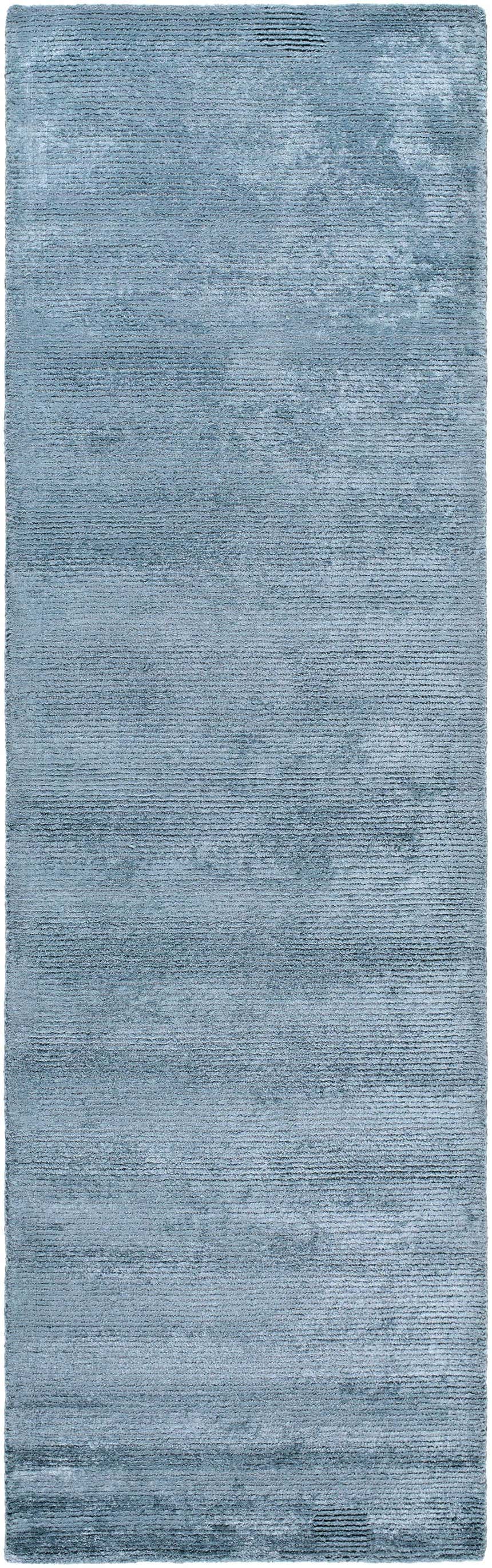 Close-up of the gray Nuray Area Rug, hand-tufted with a subtle horizontal pattern and soft, viscose texture. Design-Runner-310