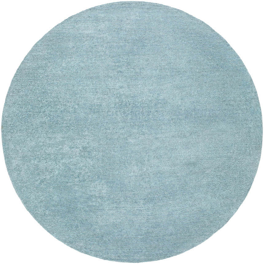 Close-up of the round Nuray Area Rug in gray and pewter, showing its subtle texture and hand-tufted construction. Design-Round-8