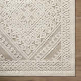Close-up of the Hibah Bone Area Rug showing its contemporary geometric design and textured beige and bone color palette. Corner