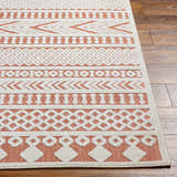 Close up of Jove Orange Outdoor Rug showing Southwestern geometric pattern in bone and terracotta. Front