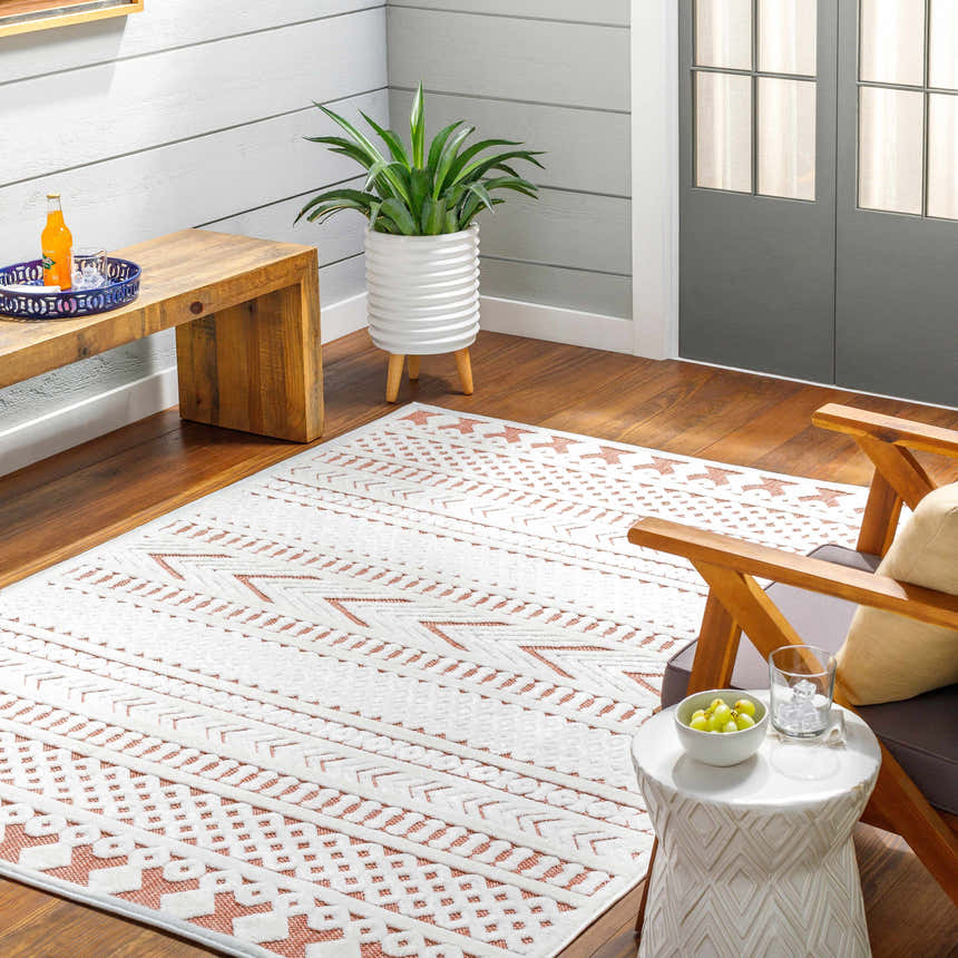 Cozy sunroom with Jove Orange Outdoor Rug, wood floors, white walls, and modern furniture. Southwestern style. Roomscene-Rectangle
