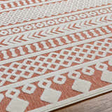 Close up of the Jove Orange Outdoor Rug showing the bone and terracotta geometric pattern. Texture