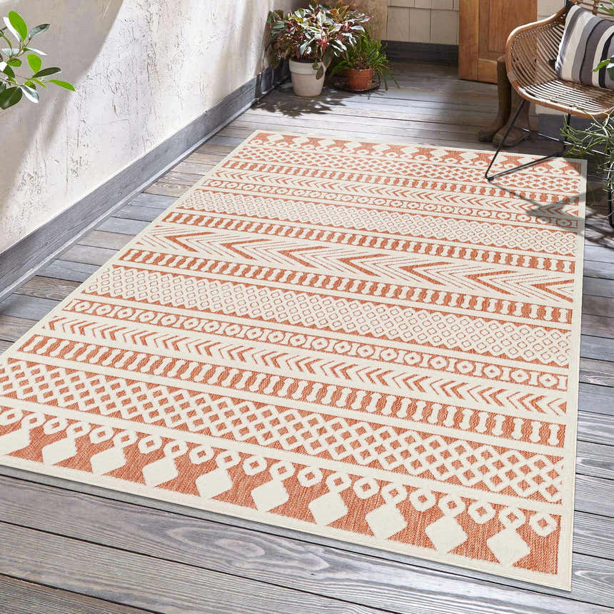 Outdoor patio scene with a Jove Orange outdoor rug, woven with Southwestern-style geometric patterns. Roomscene-Rectangle