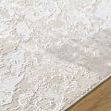 Close-up of the textured Jaren Tan Area Rug. Beige, cream, and tan tones with a subtle, contemporary pattern. Texture