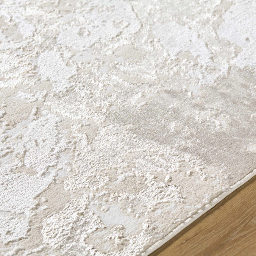 Close-up of the textured Jaren Tan Area Rug. Beige, cream, and tan tones with a subtle, contemporary pattern. Texture