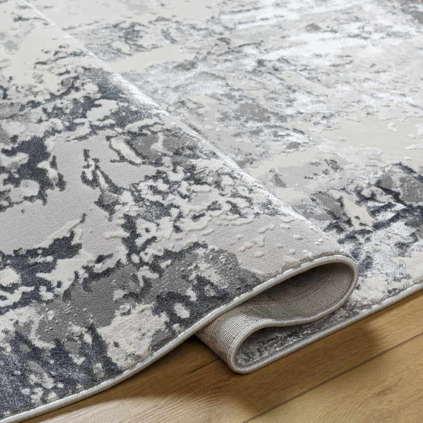 Close-up of the Junko Gray & Blue Marble Area Rug, showing its abstract pattern and textured weave. Clearance item. Fold