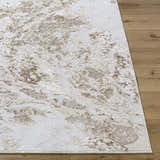 Close up of the Kaleo Area Rug showing its beige, cream, and tan abstract pattern and machine woven texture. Front