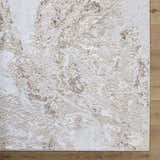 Close-up of the Kaleo Area Rug. Beige, cream, and tan abstract pattern. Contemporary style. Polyester material. Corner