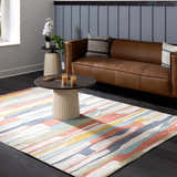 Living room scene with a Southfields Colorful Modern Area Carpet, brown leather sofa, and dark wood floors. Roomscene-Rectangle