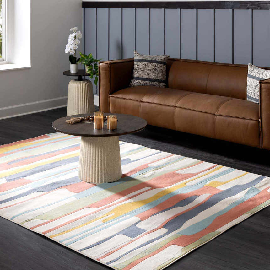 Living room scene with a Southfields Colorful Modern Area Carpet, brown leather sofa, and dark wood floors. Roomscene-Rectangle