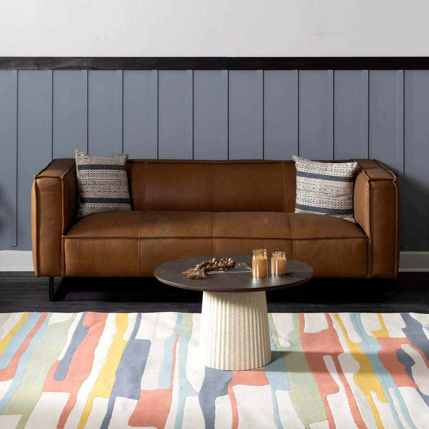 Living room scene with a brown leather sofa and Southfields Colorful Modern Area Carpet. Roomscene-Rectangle
