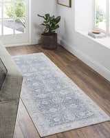 Entryway with Kayin Washable Rug in silver and gray, wood floors, gray sofa, and natural light from a window and door. Roomscene-Runner