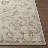 Close-up of the beige and tan Adelle Tufted Oushak Area Rug showing the wool texture and traditional floral pattern. Front
