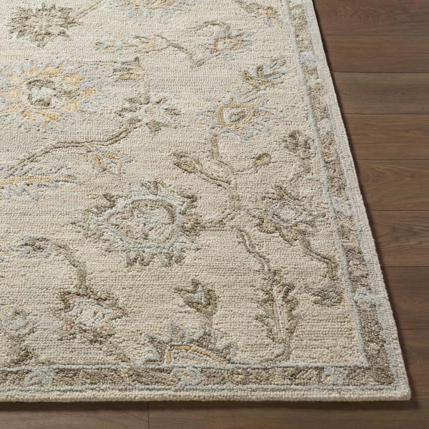 Close-up of the beige and tan Adelle Tufted Oushak Area Rug showing the wool texture and traditional floral pattern. Front