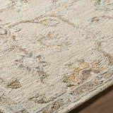 Close up of the beige and tan Adelle Tufted Oushak Area Rug, showing the hand tufted wool texture and traditional floral pattern. Texture