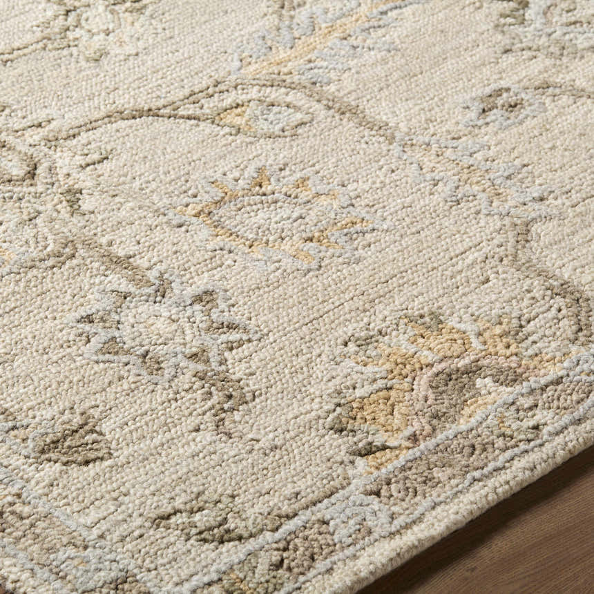 Close up of the beige and tan Adelle Tufted Oushak Area Rug, showing the hand tufted wool texture and traditional floral pattern. Texture