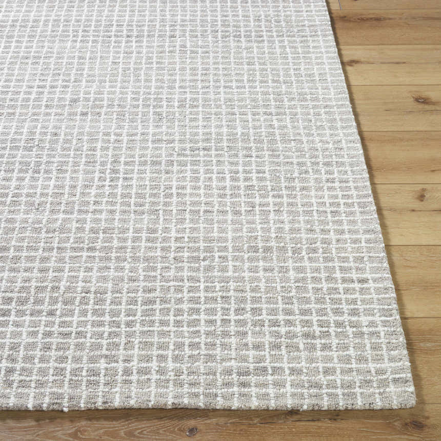 Close-up of the hand-tufted Anahid Gray Area Rug. Checkered pattern in ash, light silver, and off-white wool on wood floor. Front