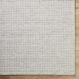 Close-up of the Anahid Gray Area Rug. Checkered pattern in ash, light silver, and off-white wool texture. Swatch