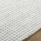 Close-up of the hand-tufted Anahid Gray Area Rug. Checkered pattern in ash, light silver, and off-white wool. Texture
